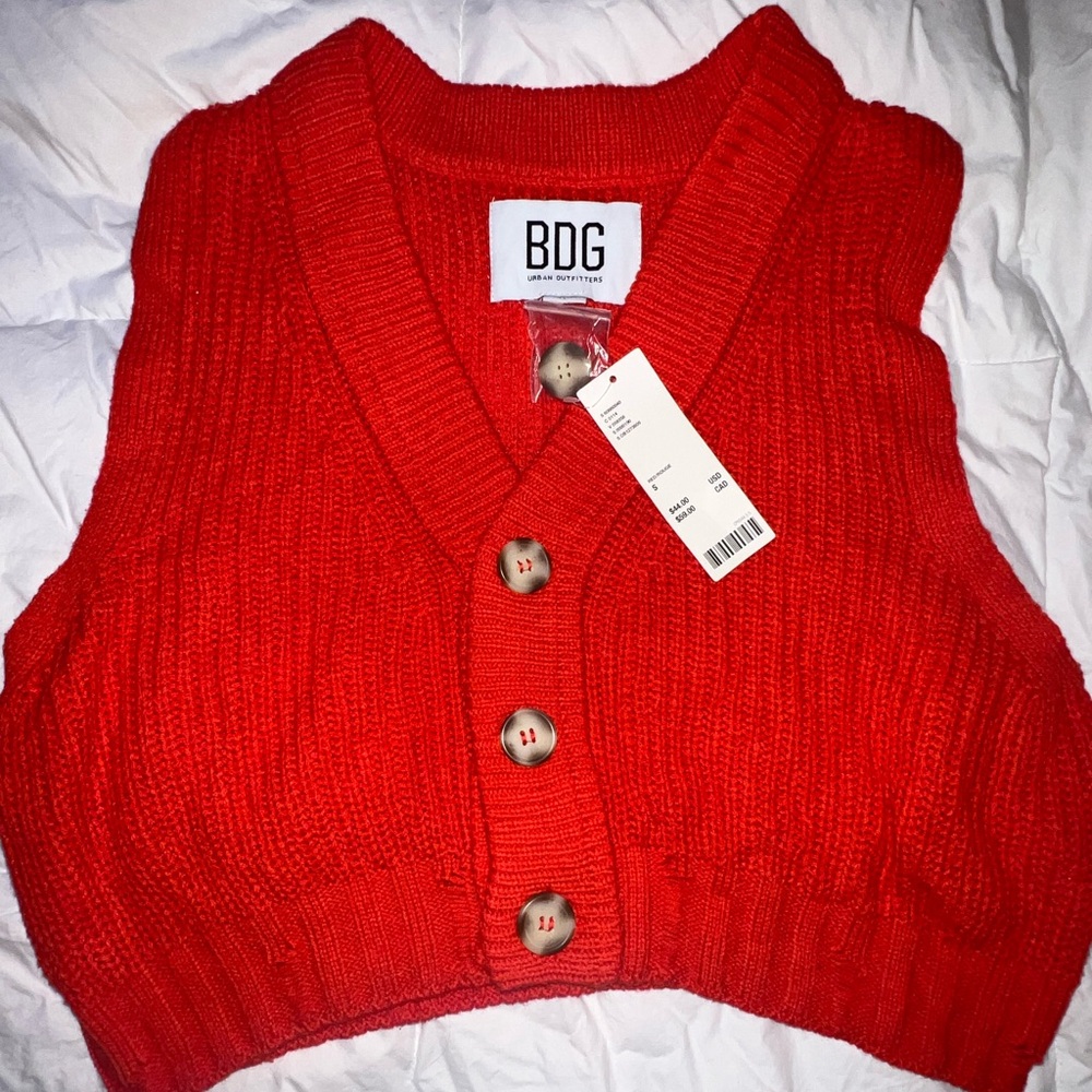 Urban Outfitters orange sweater vest.